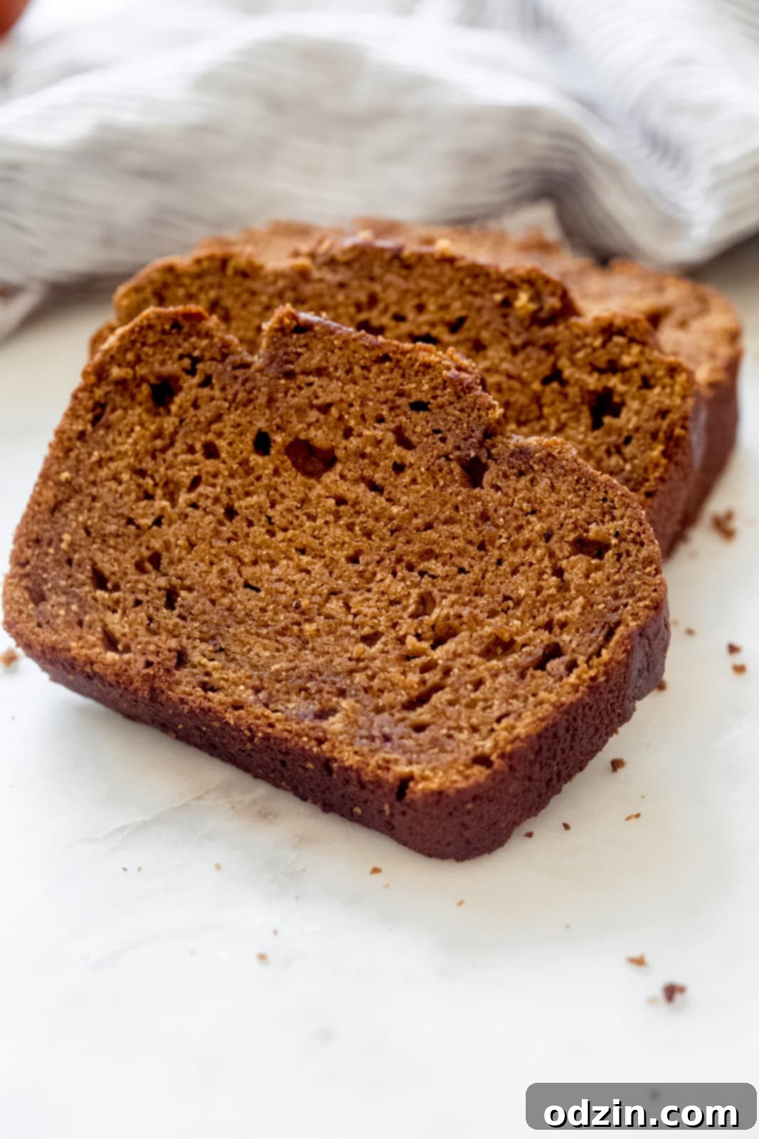 thick slices of brown butter pumpkin bread on a rustic wooden cutting board