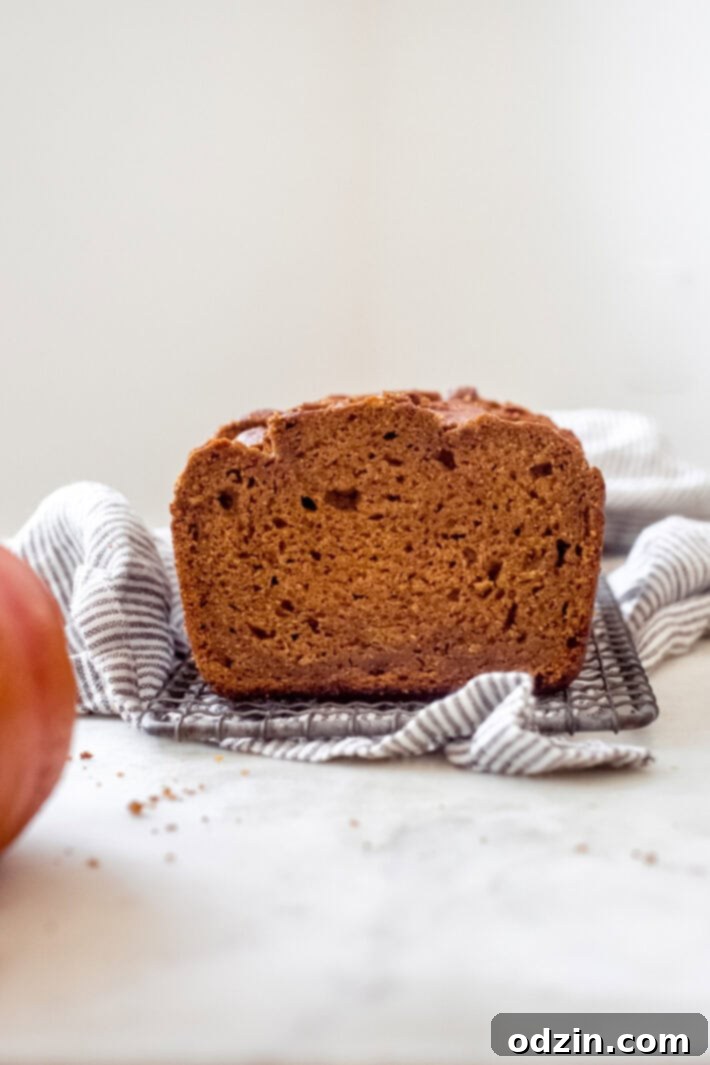 close-up showing the moist texture of spiced brown butter pumpkin bread on a wire rack