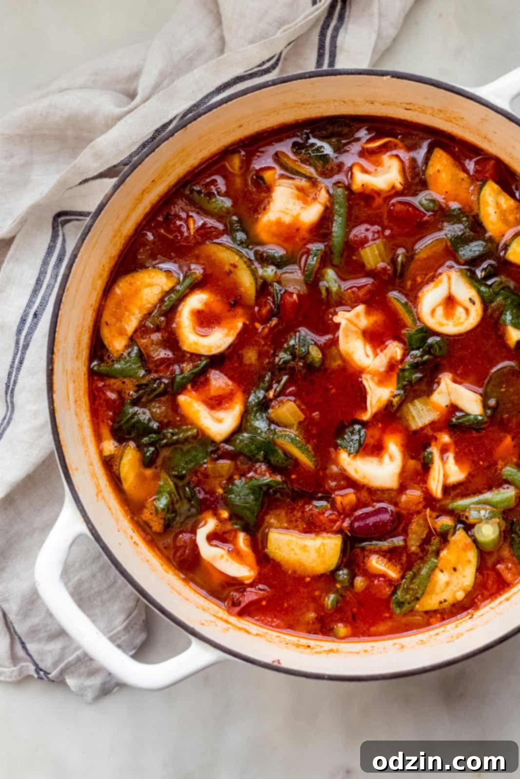 white cast iron pot with homemade tortellini minestrone soup