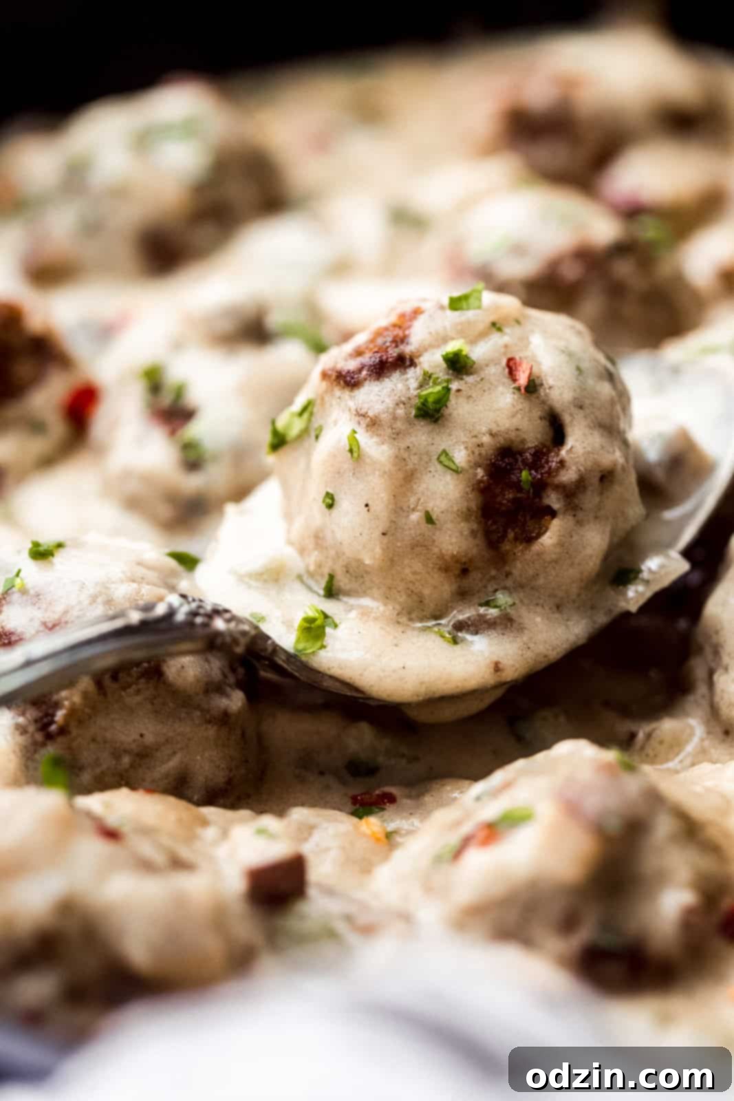 Philly Cheesesteak Meatballs with Creamy Garlic Cheese Sauce 3 spoon with cheese sauce and beef meatball