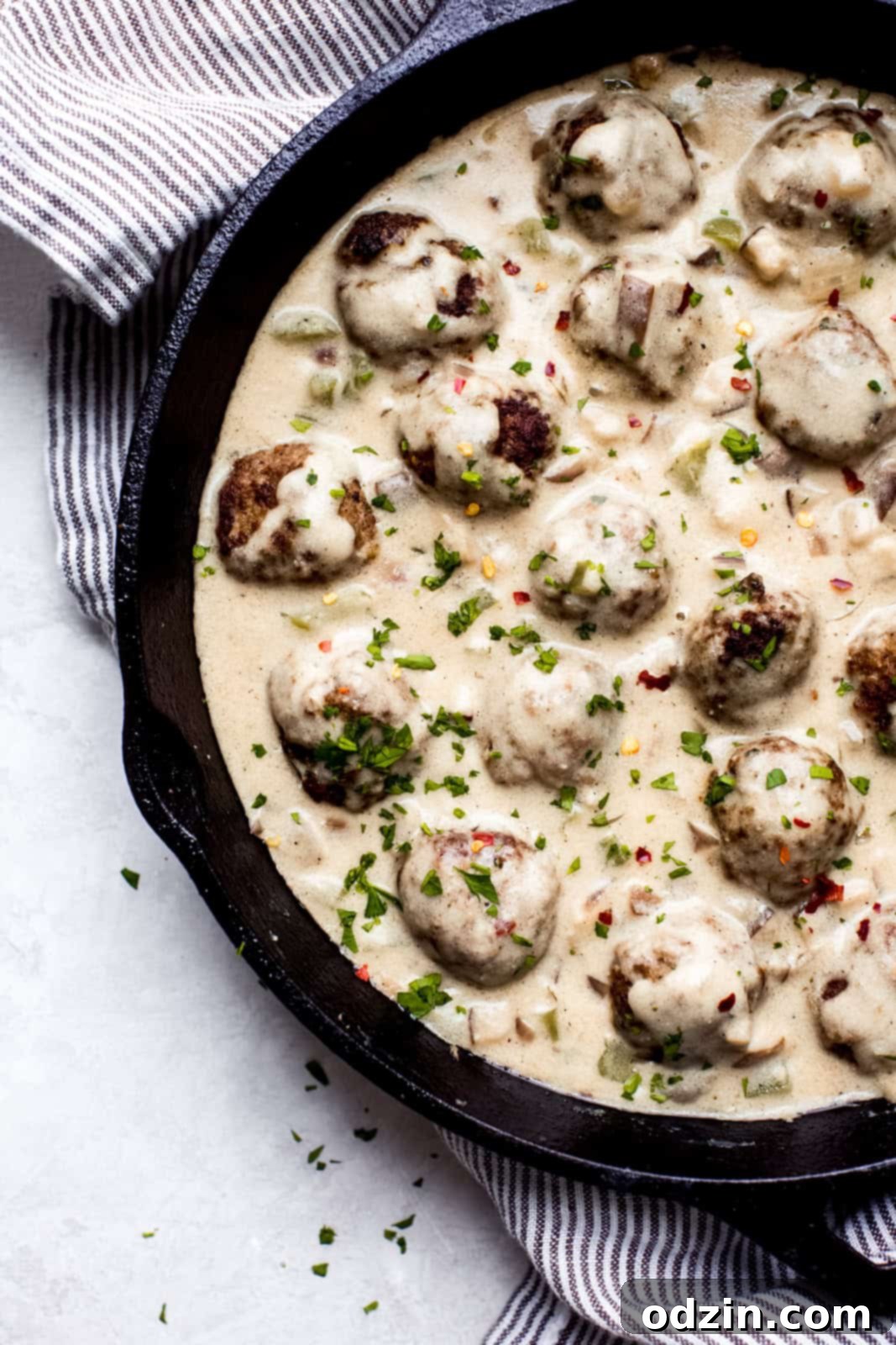 Philly Cheesesteak Meatballs with Creamy Garlic Cheese Sauce 4 cast iron skillet with meatballs in cheese sauce