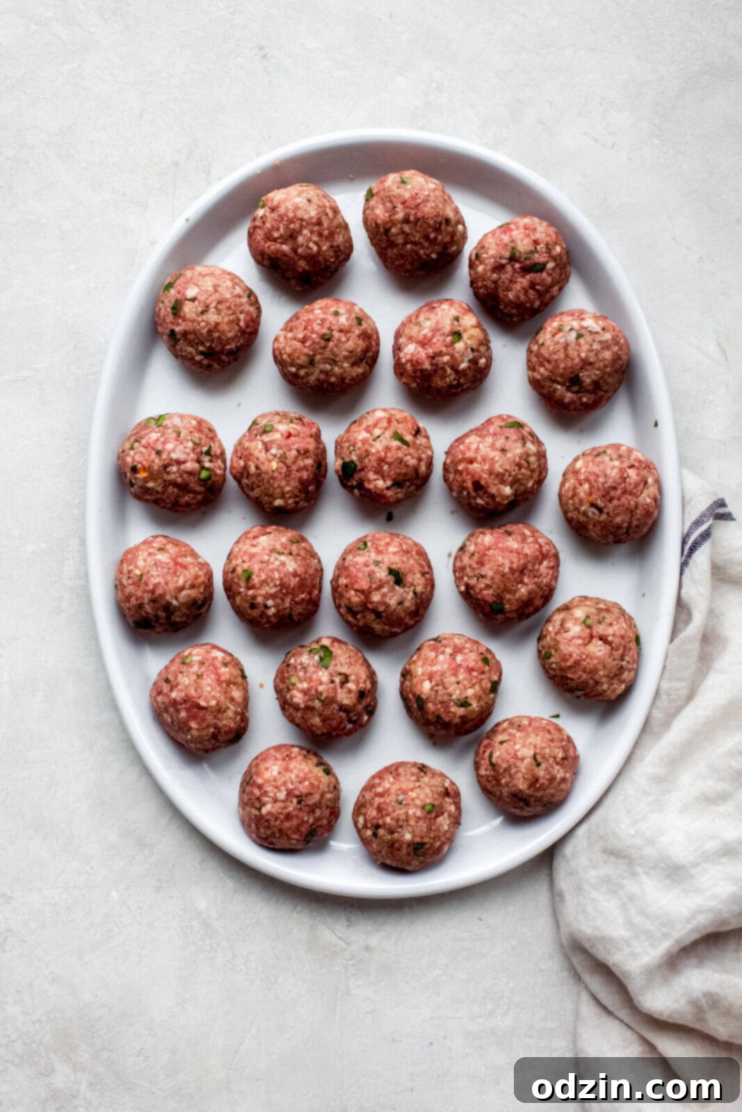 Philly Cheesesteak Meatballs with Creamy Garlic Cheese Sauce 6 prepared meatballs on white plate