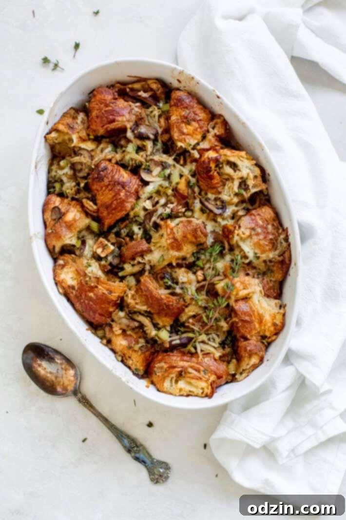 A dish of golden brown caramelized onion croissant stuffing ready to be served.