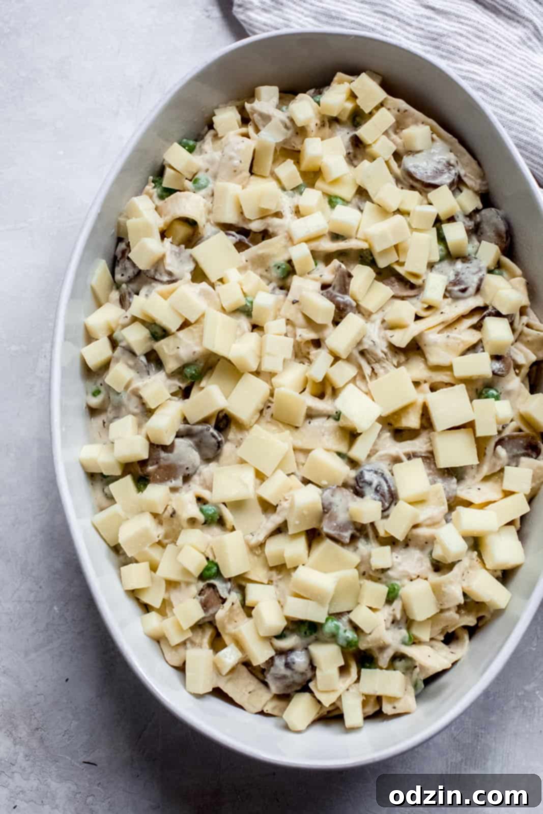 Cozy Leftover Turkey Pasta Bake Works With Chicken Too 7 oval baking dish with pasta topped with cubed cheese