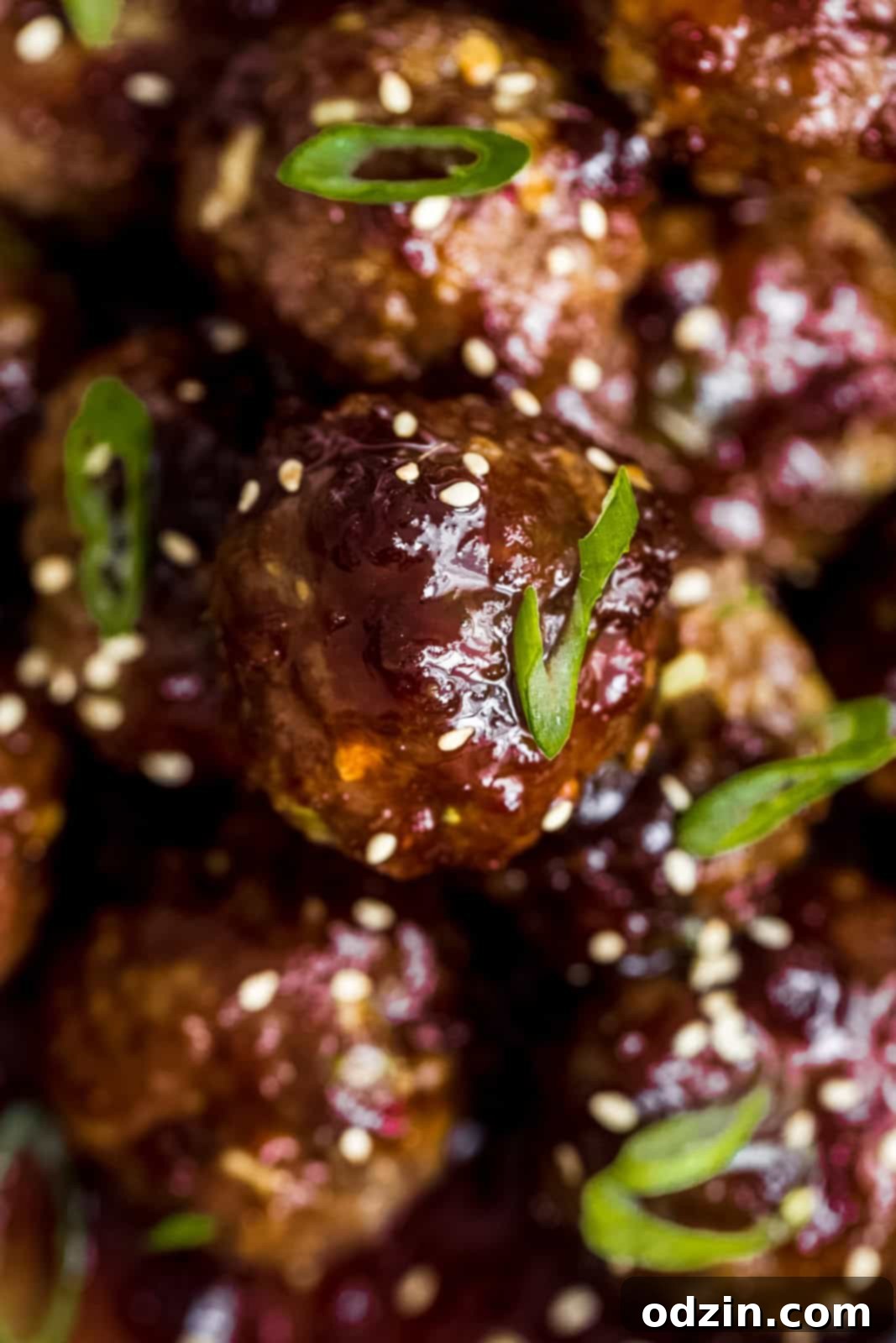 Sweet and Sticky Mongolian Beef Meatballs 7 sticky sauce on beef meatballs topped with scallions and sesame seeds