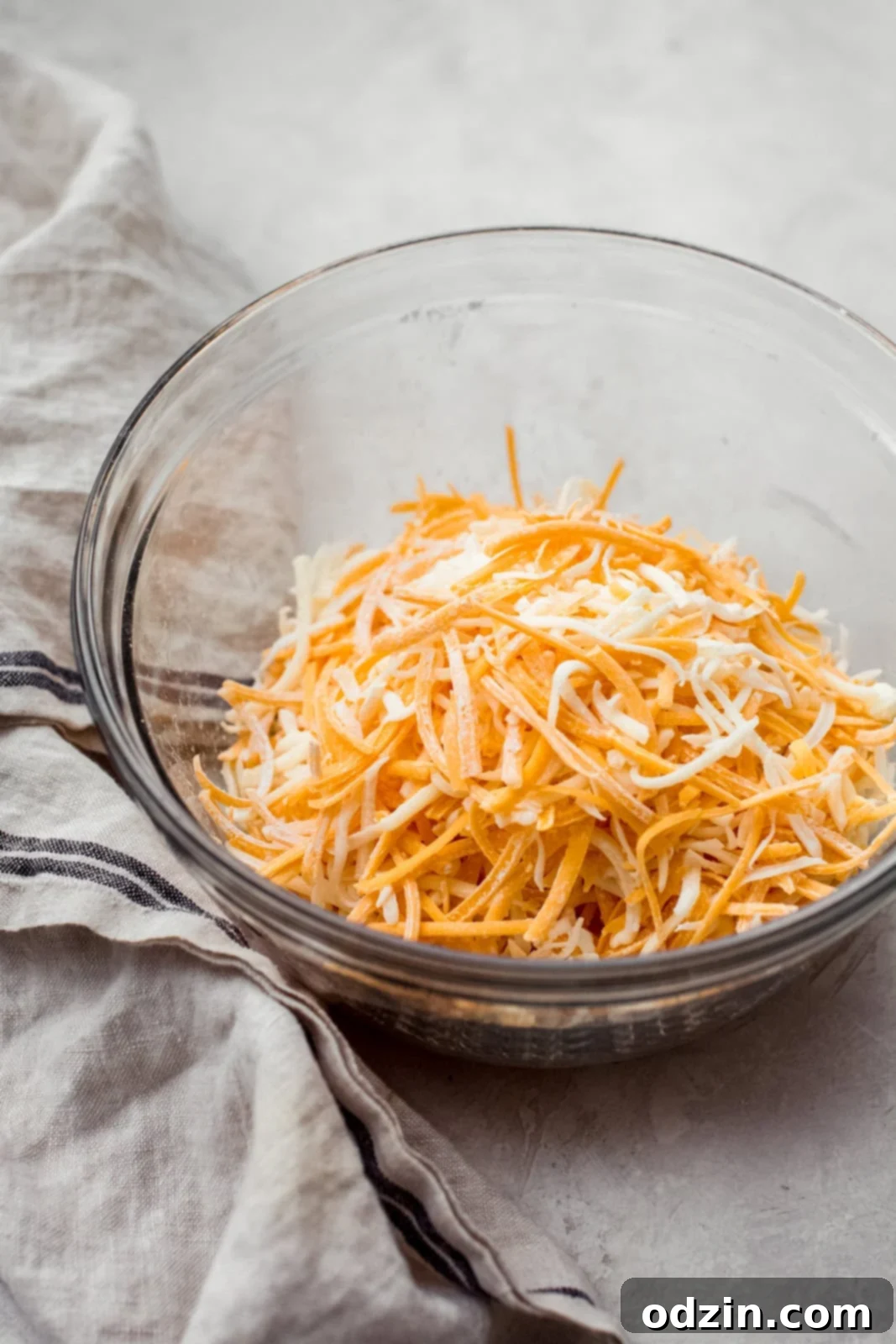 Zesty Texas Green Chili Queso 5 shredded cheese in glass bowl