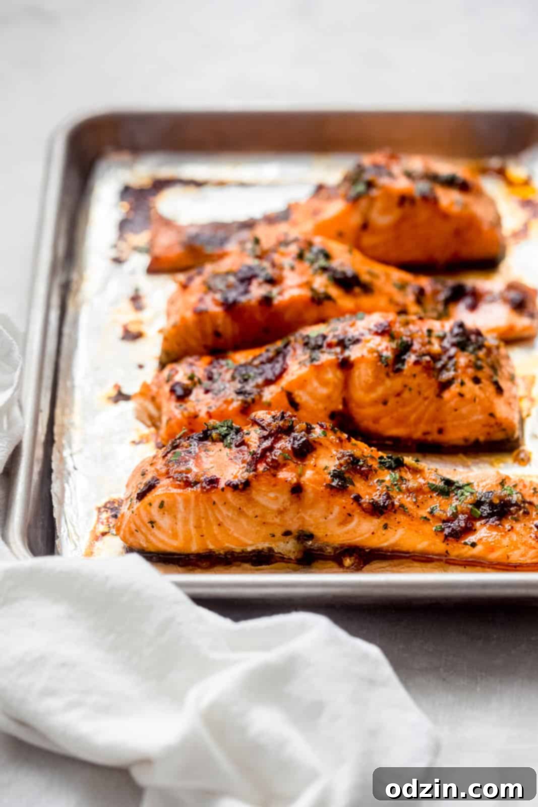 Freshly roasted Honey Chipotle Salmon fillets on a baking sheet, showing a slight char from broiling