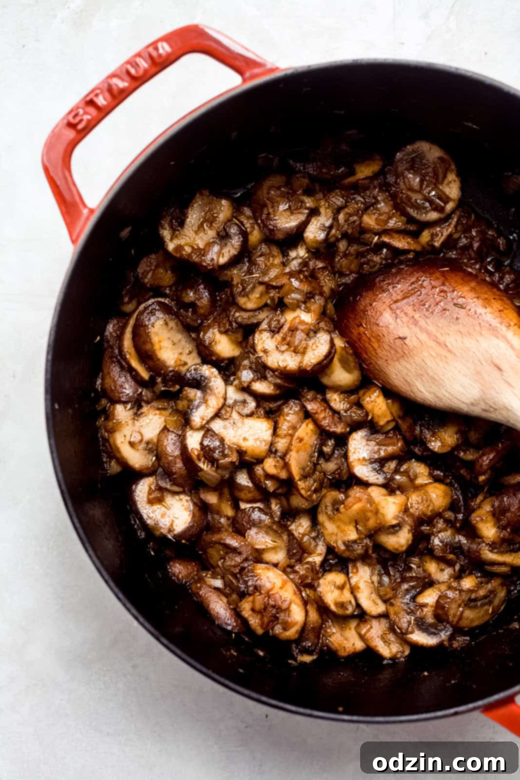 Rich & Comforting Hungarian Mushroom Soup 5 sautéed mushrooms in a pot with wooden spoon