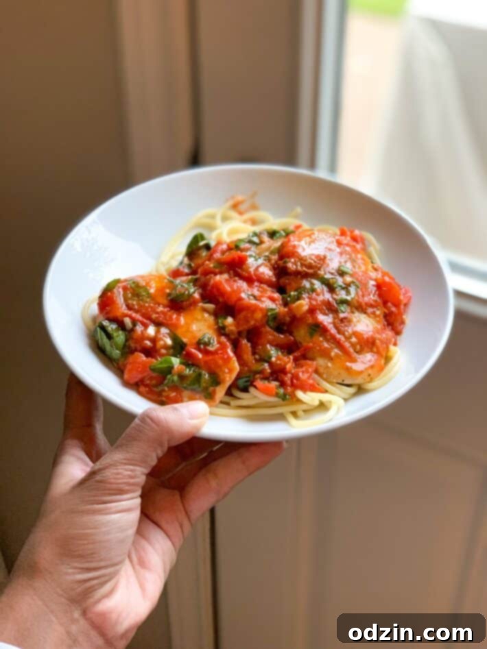 Chicken in Tomato Butter Sauce on white plate