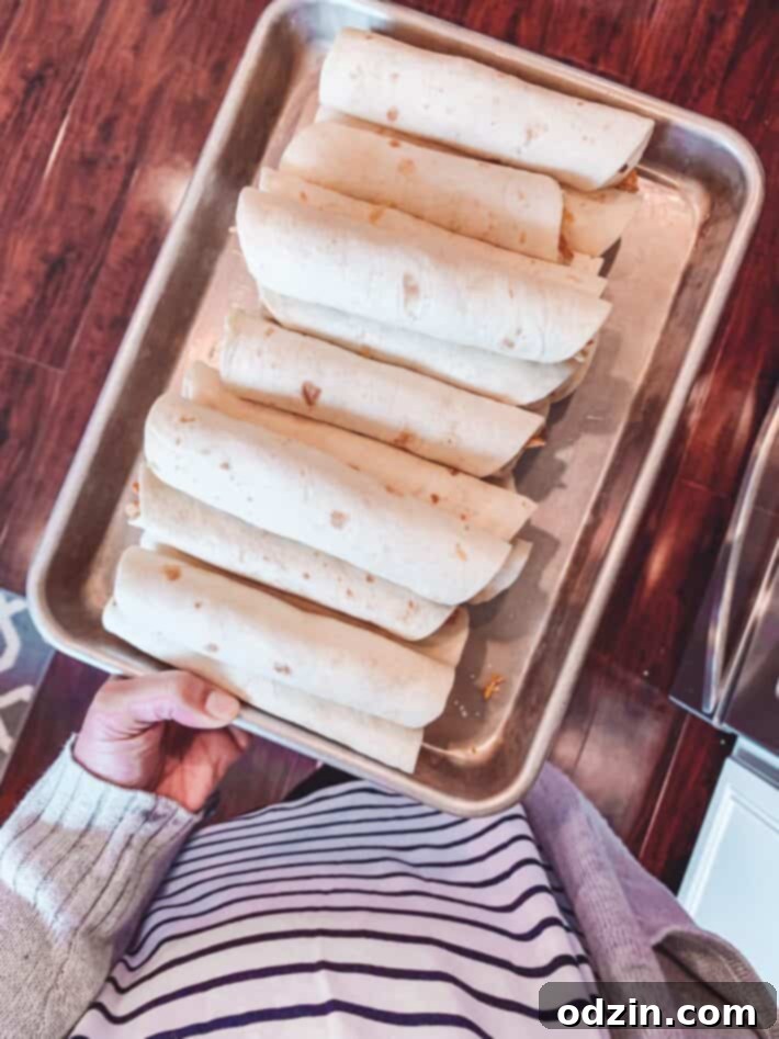 Homemade Taquitos on sheet pan ready to be Fried