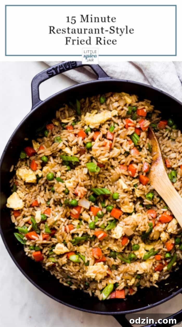 prepared fried rice in a cast iron pot with wooden spoon