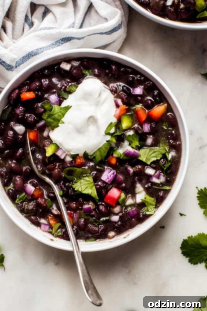 top shot of cuban black bean soup with dollop of sour cream