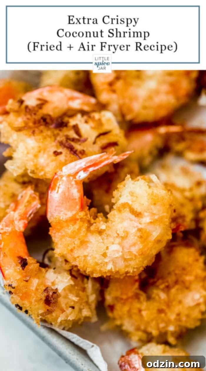 close up of fried crispy coconut shrimp from the top on sheetpan