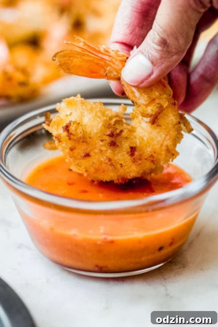 coconut shrimp dipped in dynamite sauce