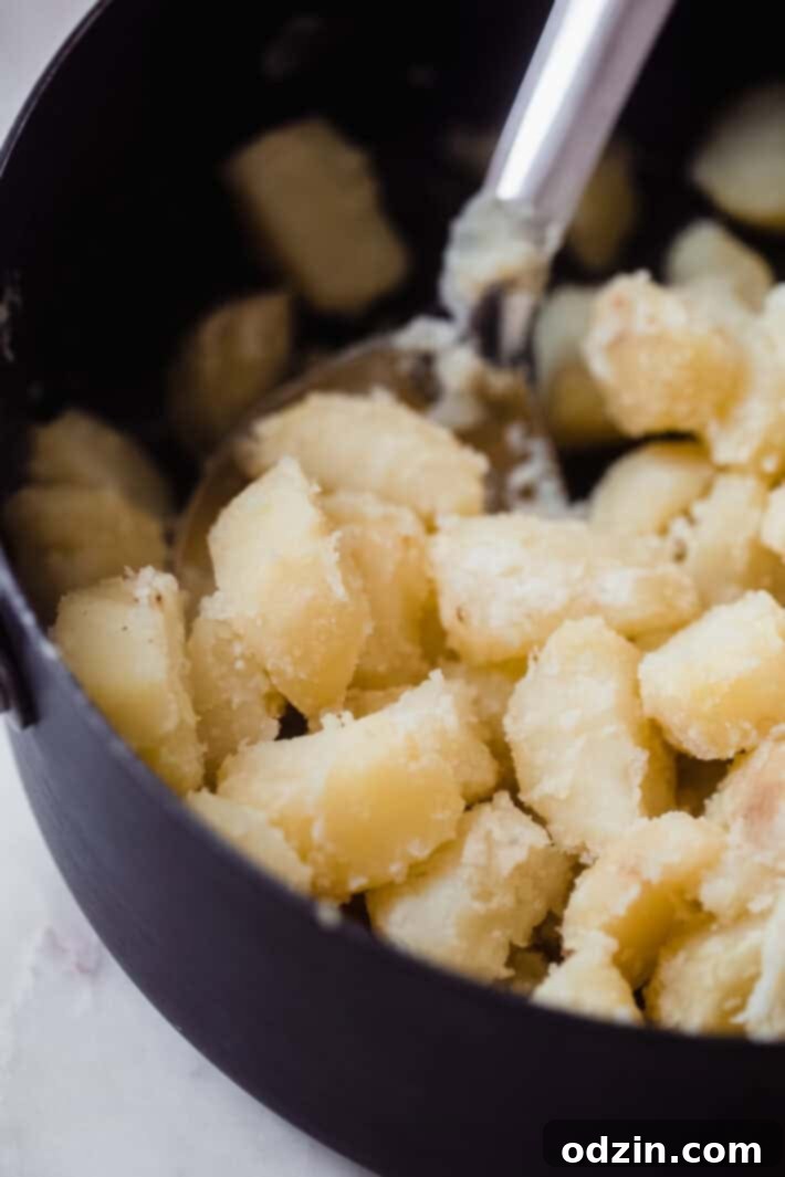 Crispy Garlic Oven Potatoes 4 close up of parboiled potatoes in stock pot