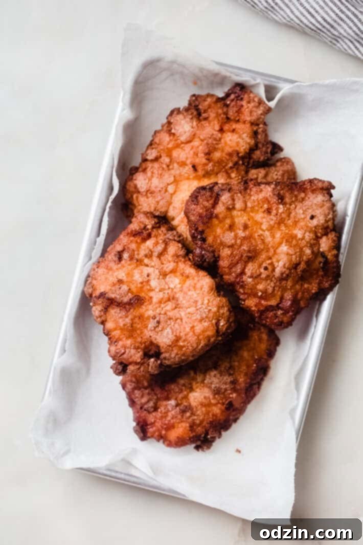 Signature Pickle Crunch Chicken Sandwich 5 fried chicken breasts on sheet pan lined with paper towel