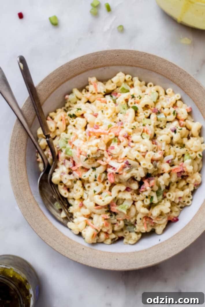 Crave-Worthy Macaroni Salad 2 bowl of macaroni salad surrounded by sweet relish and prepared salad dressing