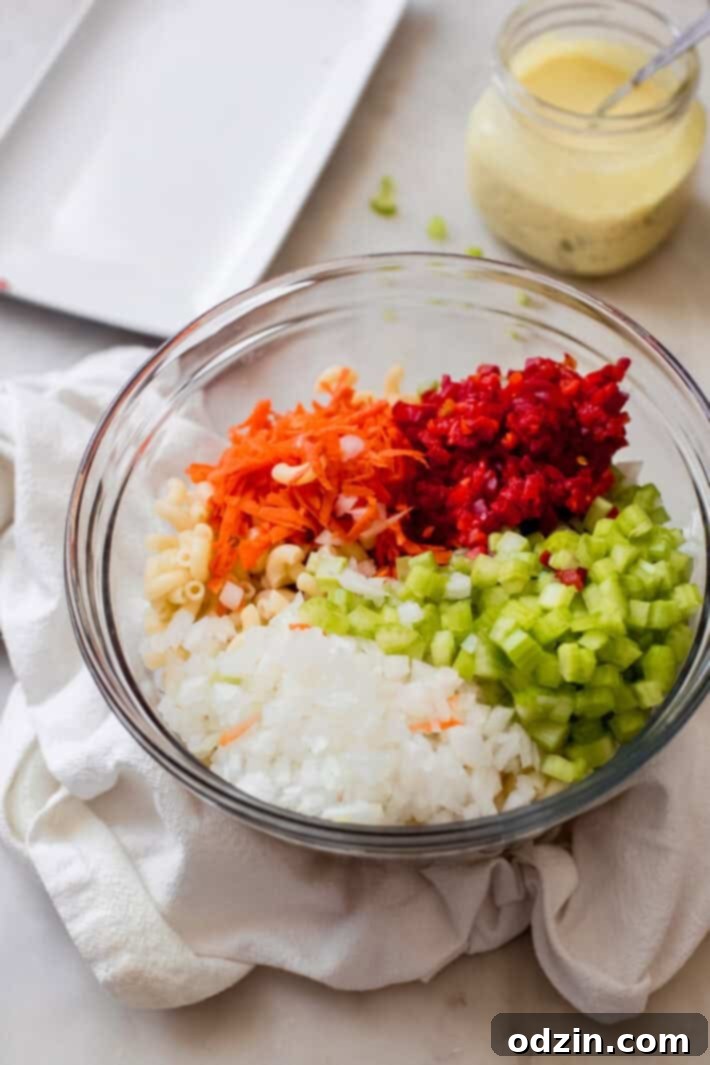 Crave-Worthy Macaroni Salad 4 all the ingredients macaroni salad in a glass bowl ready to be dressed
