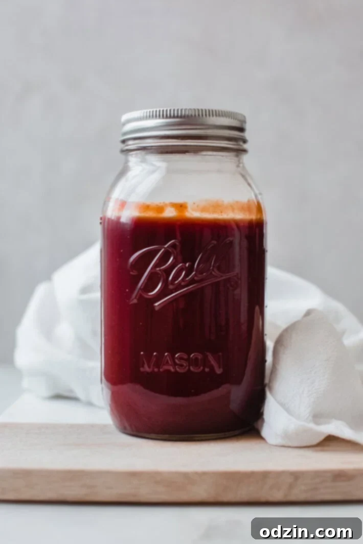 prepared sweet bay ray's bbq sauce in mason jar on wood surface with white tea towel