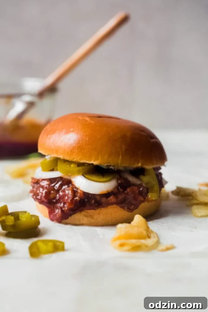 bbq beef brisket sandwich with sliced onions and pickled jalaepenos on brioche bun