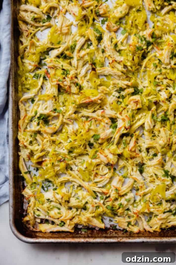 Zesty 5-Ingredient Pepperoncini Chicken 6 Prepared and browned crispy pepperoncini chicken on a baking sheet, garnished with fresh chopped cilantro