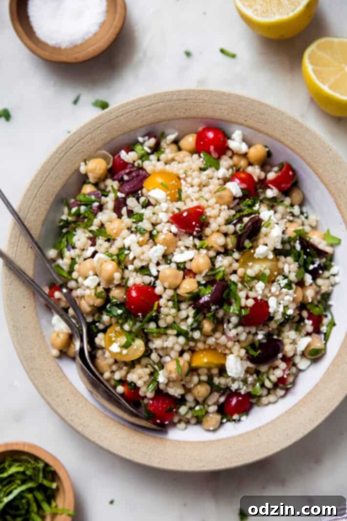 top shot of prepared salad in rimmed bowl on white marble