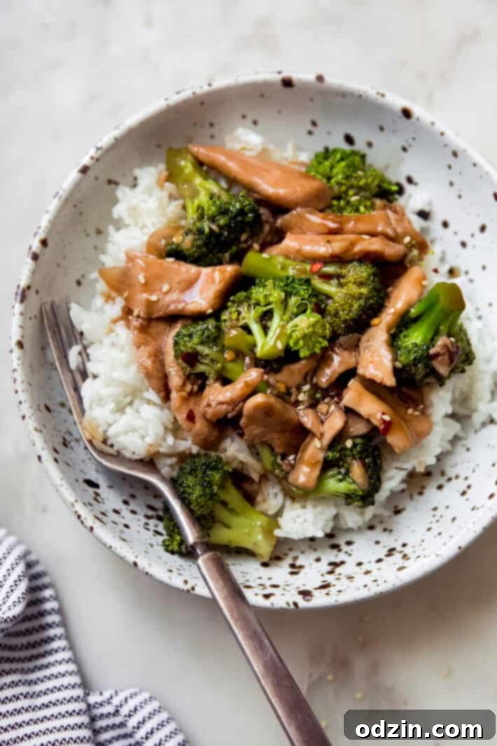 speckled bowl with fork, fluffy white rice, topped with prepared stir fry