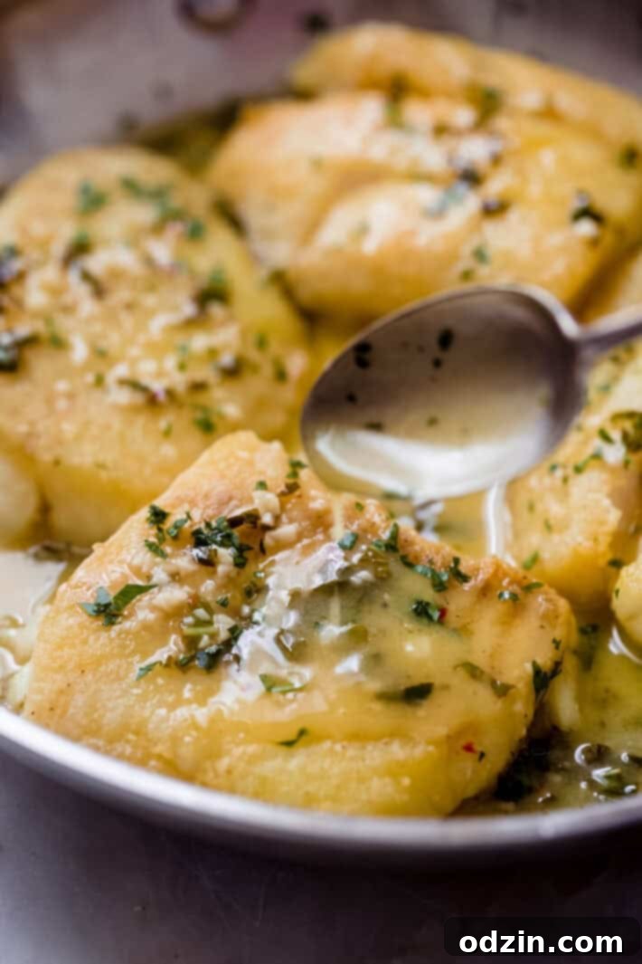 The Ultimate Pan-Fried Fish with Fresh Basil and Zesty Lemon Butter 3 spoon pouring lemon butter on pan fried fish filet