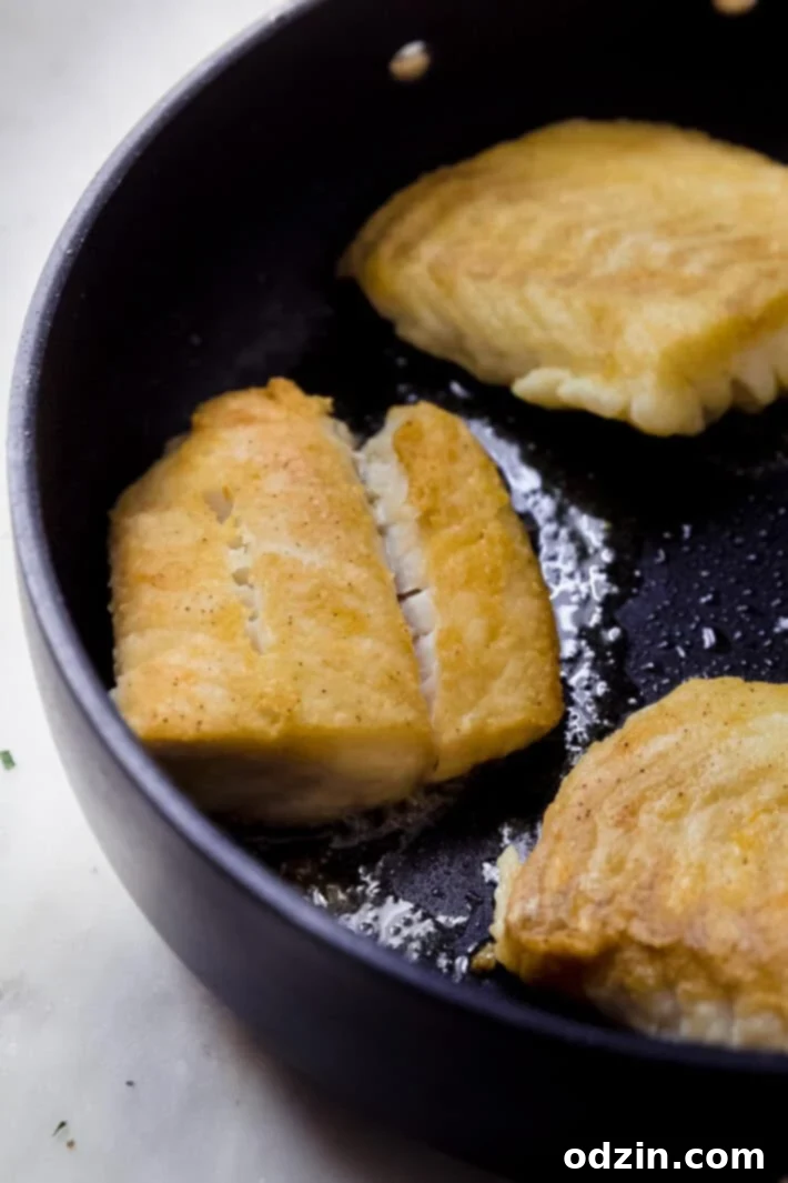 The Ultimate Pan-Fried Fish with Fresh Basil and Zesty Lemon Butter 4 pan fried fish in nonstick skillet