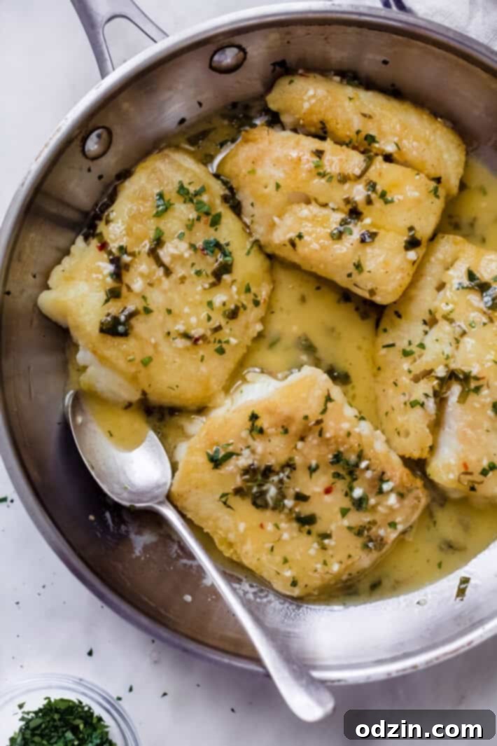 The Ultimate Pan-Fried Fish with Fresh Basil and Zesty Lemon Butter 5 prepared fish with spoon in skillet