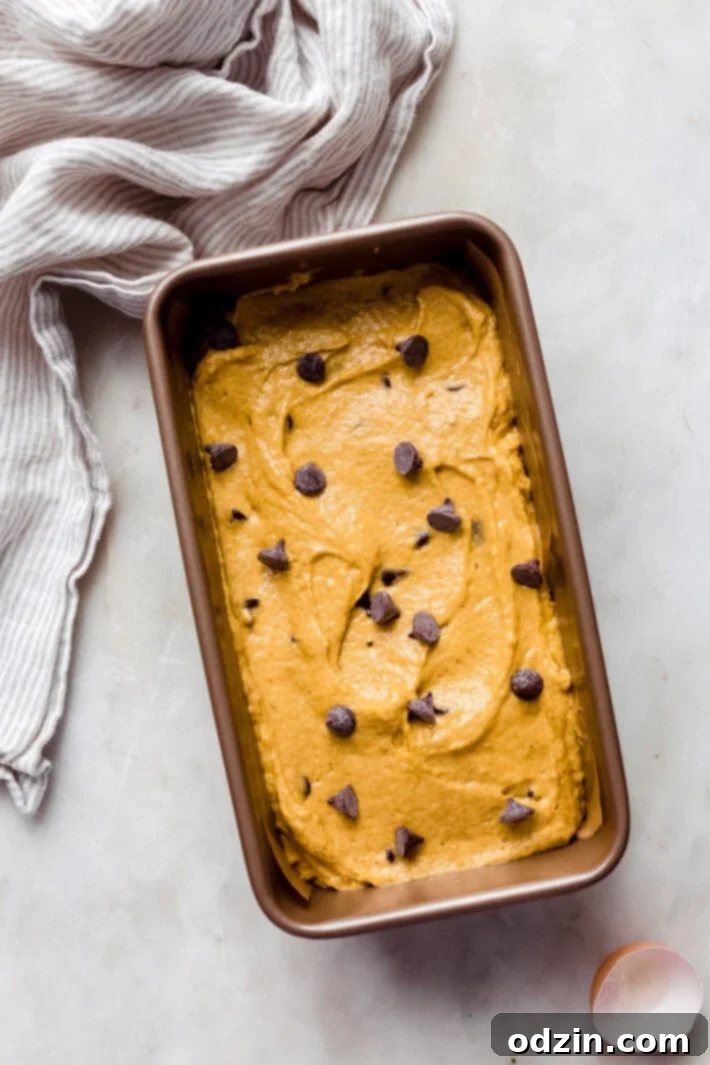 pumpkin bread batter in baking pan before baking on white marble