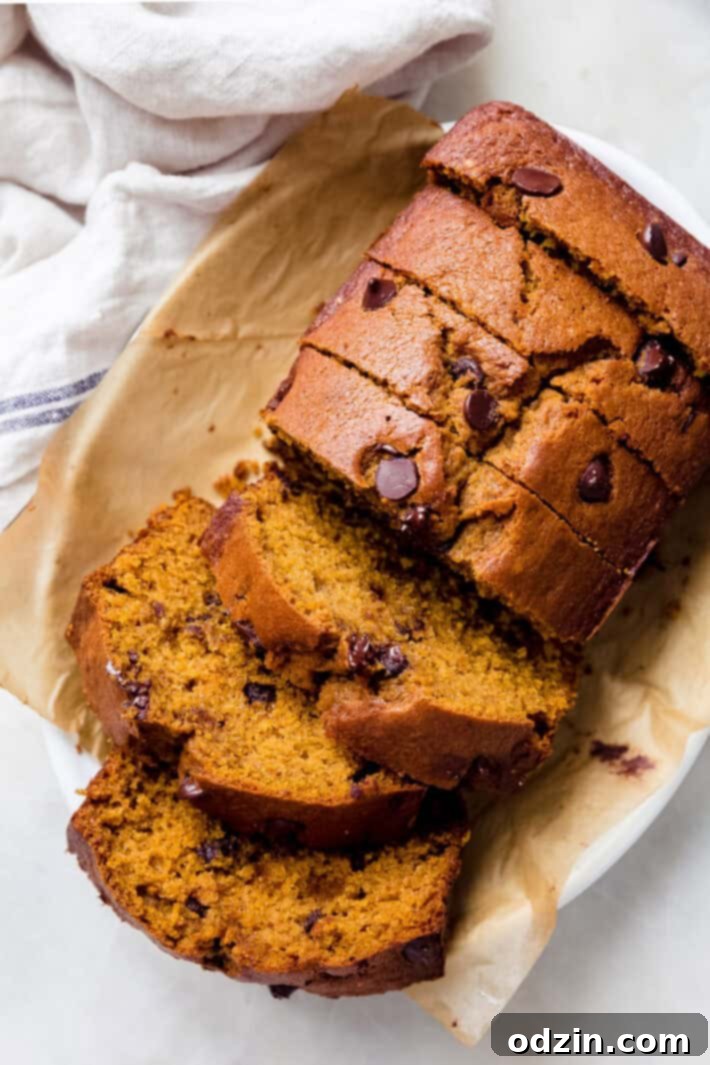 cascading slices of pumpkin bread on white plate on white marble