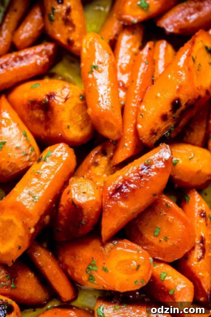 close up of roasted carrots tossed in honey garlic butter sauce