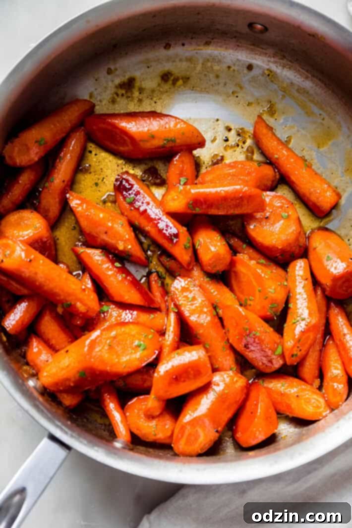 roasted carrots in saute pan tossed in sauce