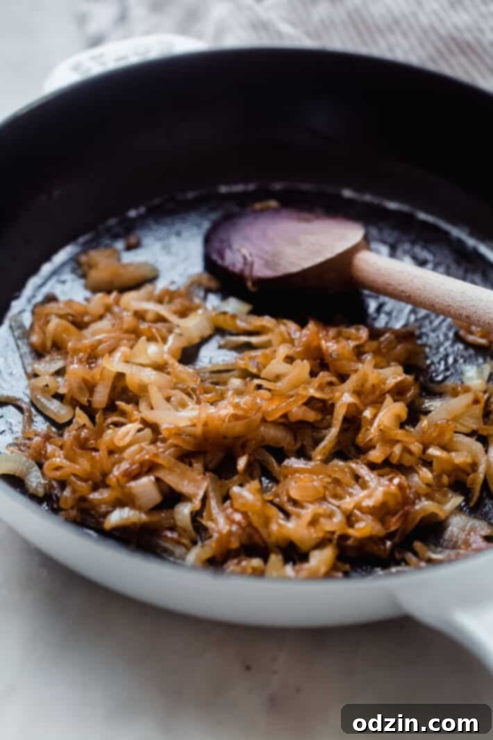 Sweet and savory caramelized onions cooking in a cast-iron skillet