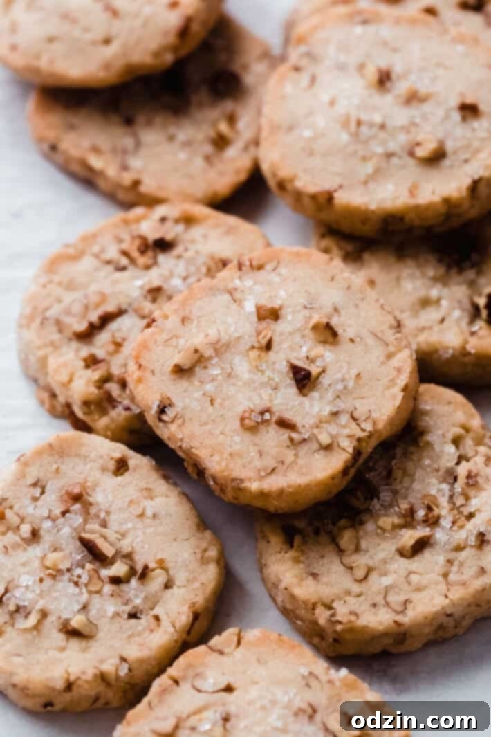 pecan shortbread cookies on white parchment paper