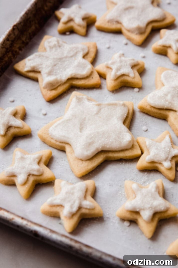 The Ultimate Cut-Out Sugar Cookies: 5 Tips for Baking Perfection 11 baking sheet filled with star shaped frosted cookies