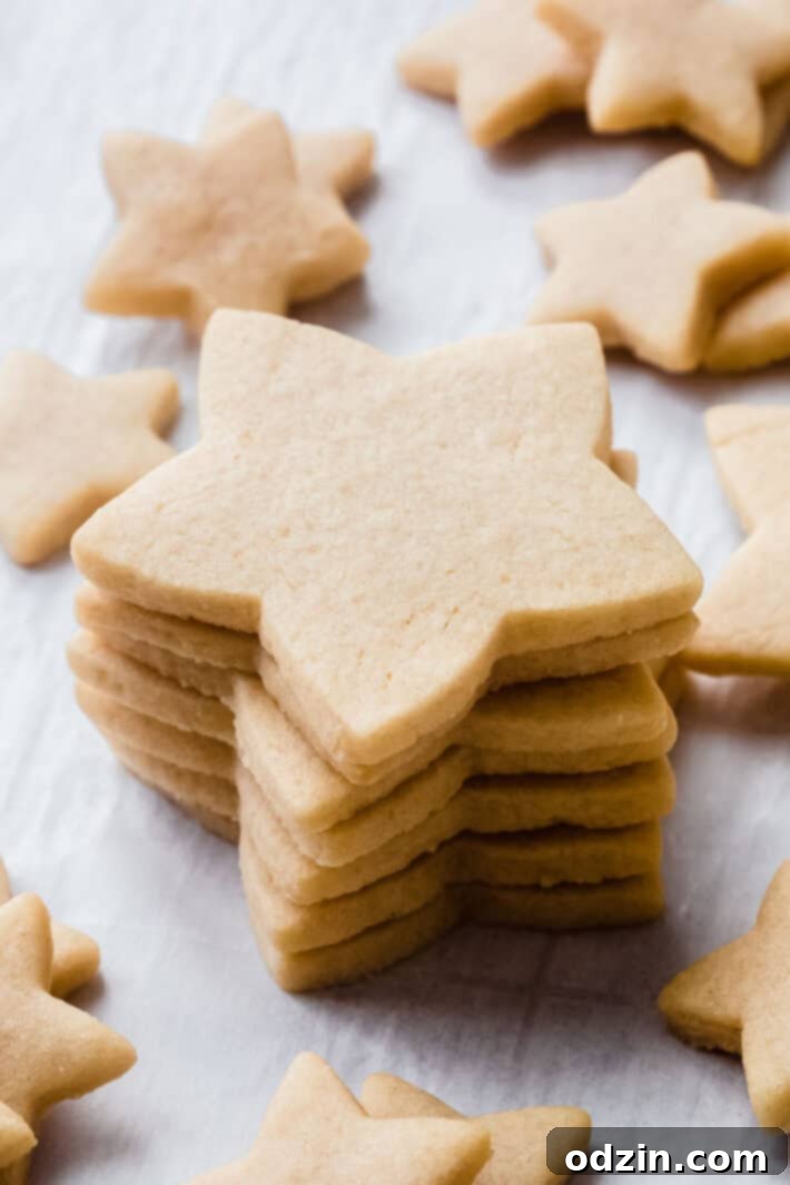 The Ultimate Cut-Out Sugar Cookies: 5 Tips for Baking Perfection 9 stack of star shaped cookies on white parchment
