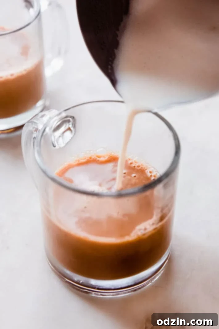 Effortless London Fog Latte 6 frothed milk being poured into earl grey latte