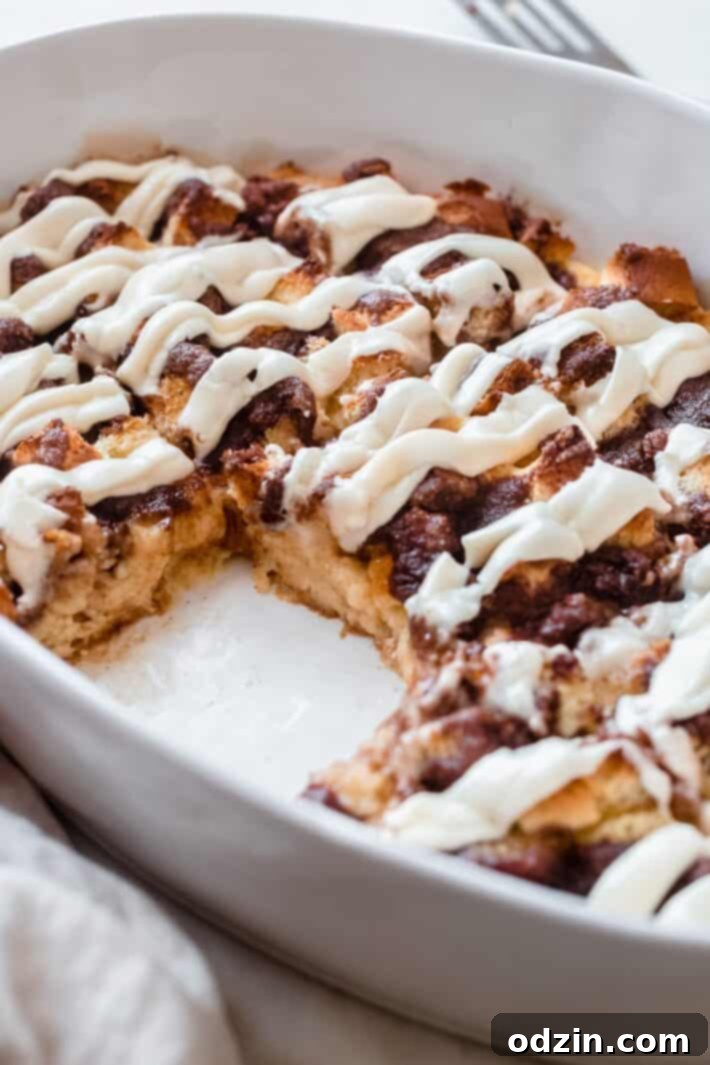a piece of cinnamon roll casserole missing from dish, shows inside texture