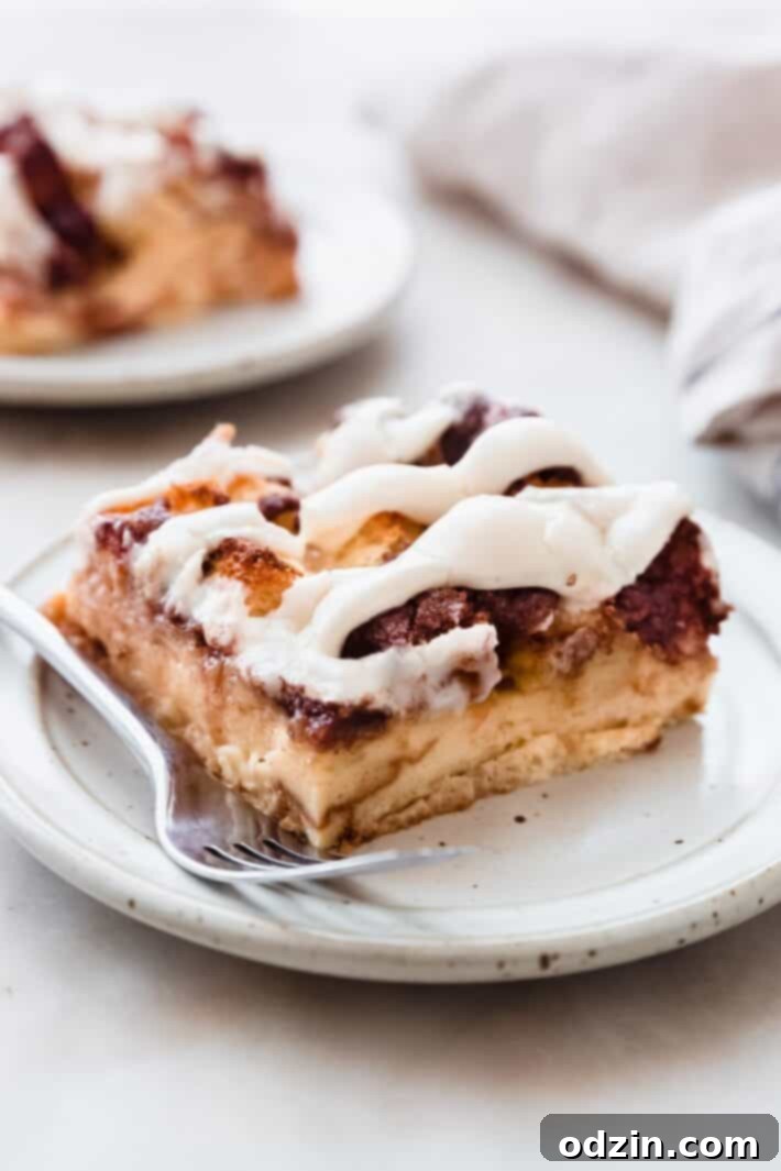 piece of casserole on plate with fork on white marble