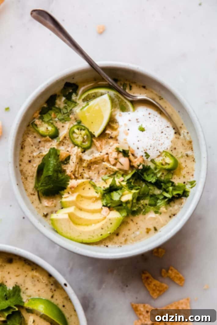 Creamy White Chicken Chili in a bowl, garnished with cilantro and avocado