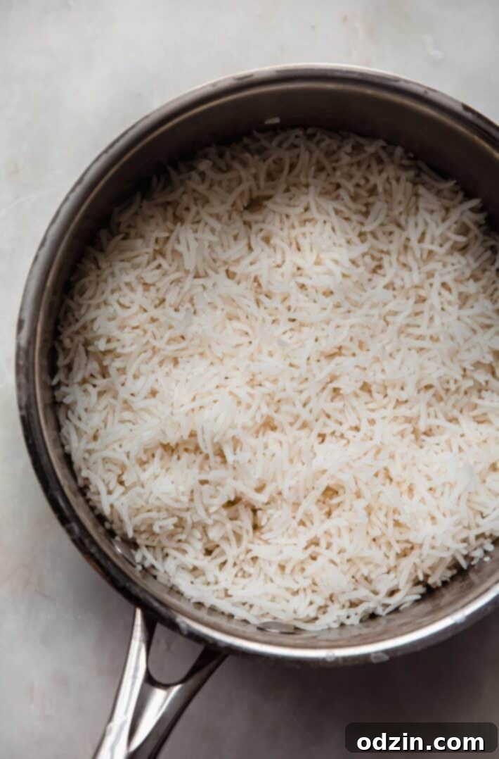 The Secret to Fluffy Indian Restaurant Basmati Rice 6 cooked basmati rice in saucepan