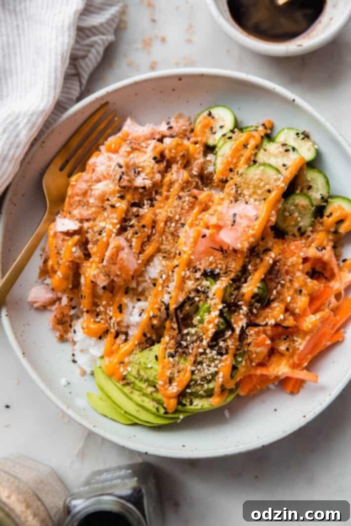 Your Go-To Weeknight Salmon Sushi Bowls 8 fork in bowl with wasabi soy sauce bowl on the side and tea towel