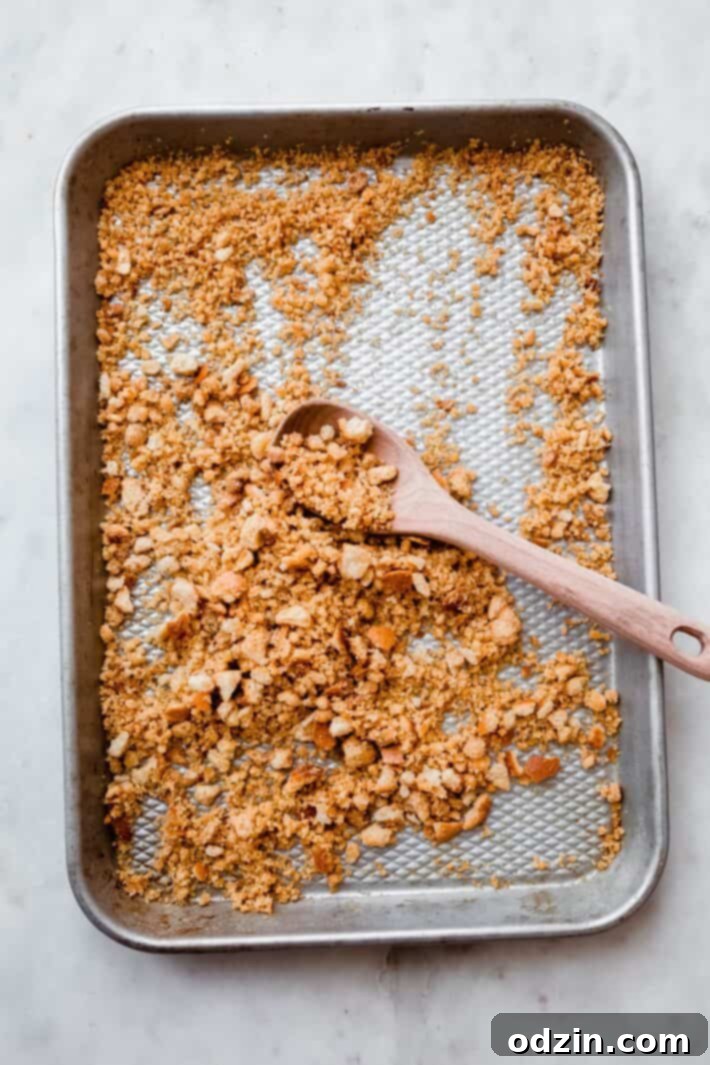 parmesan toasted bread on rimmed baking sheet with wooden spoon