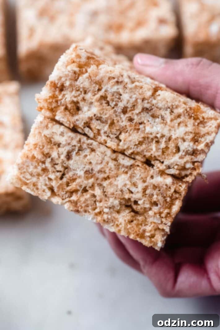 Golden Brown Butter Toasted Marshmallow Krispie Treats 8 Stack of two perfectly crafted Rice Krispies Treats held in hand, showing their irresistible appeal.
