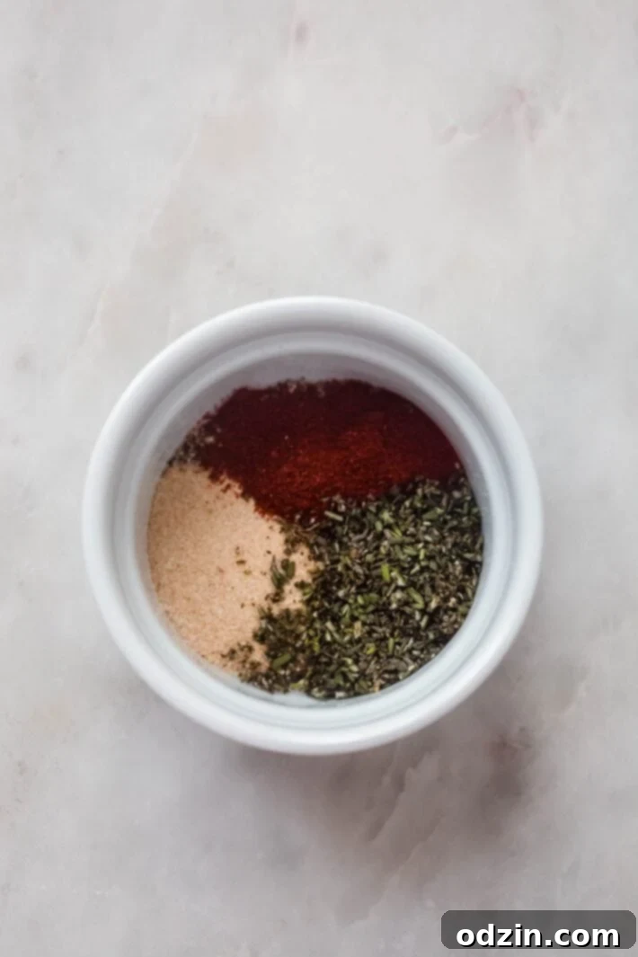 rotisserie seasonings in a white ramekin on white marble