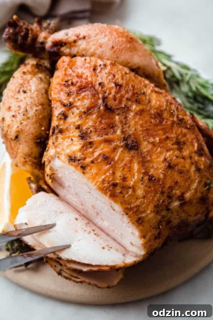 sliced whole chicken showing inside on white marble