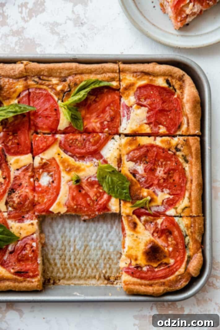 A missing quiche square from the sheet pan, highlighting a perfectly baked, golden-brown crust and inviting filling.