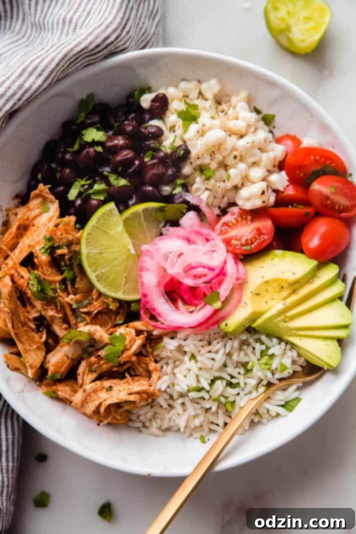 Smoky Instant Pot Chicken Tinga Bowls 2 Chicken Tinga bowl topped with black beans, corn, tomatoes, pickled onions, and avocados
